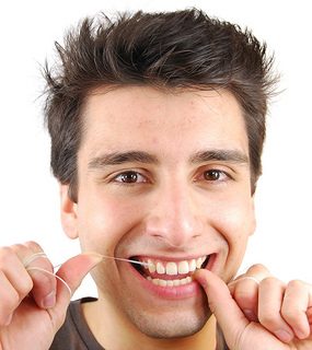 Picture of a man flossing his teeth