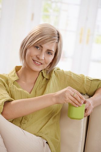 A woman is holding a mug