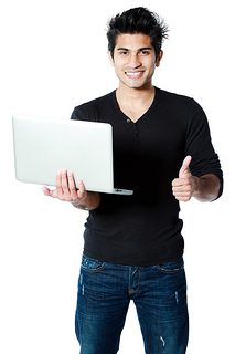 A handsome man is holding a laptop