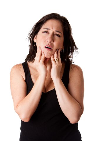Woman holding jaws due to toothpain