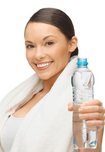 The woman is holding a bottle of water