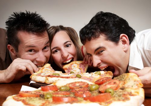 Family eating cheesy pizza