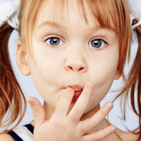 Young girl sucking index finger