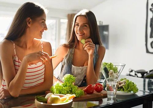 Two girls are having their snacks