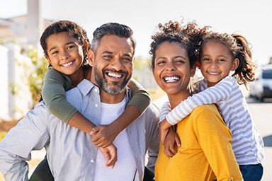 Multiethnic-parents-giving-children-piggyback-ride