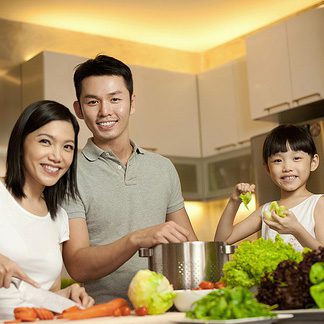 Family in kitchen smiling